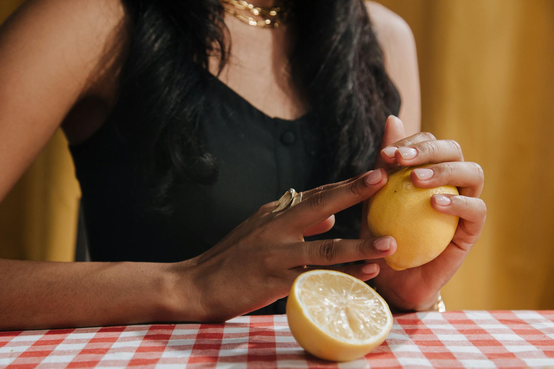A hand holding a bright vibrator, representing modern pleasure tools and intimate wellness.