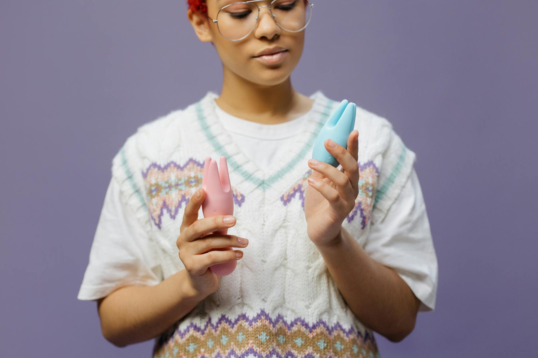 Woman holding colorful vibrators, representing choices for managing rapid orgasm and extending pleasure.