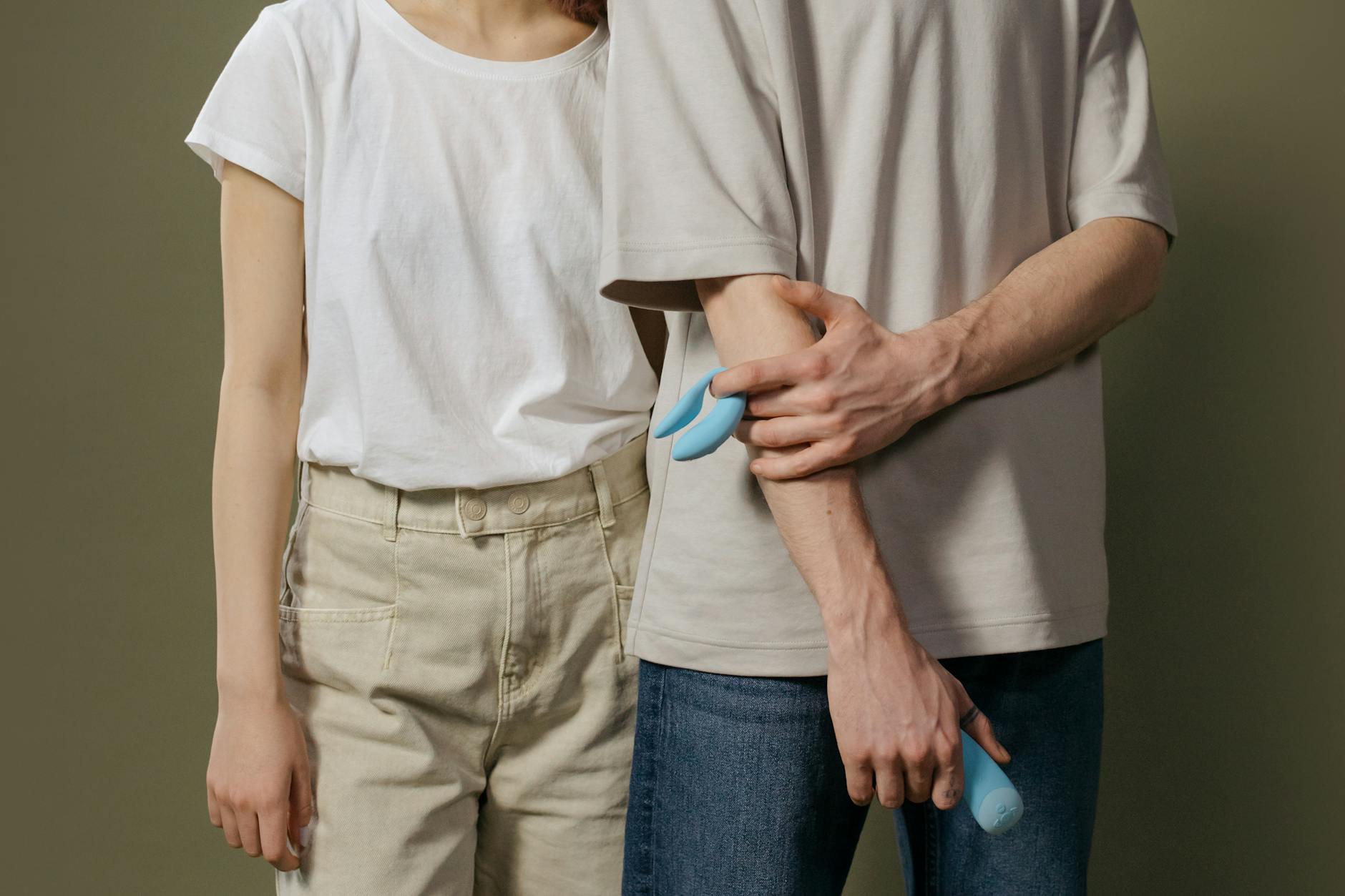 A couple standing together intimately, expressing comfort and connection.