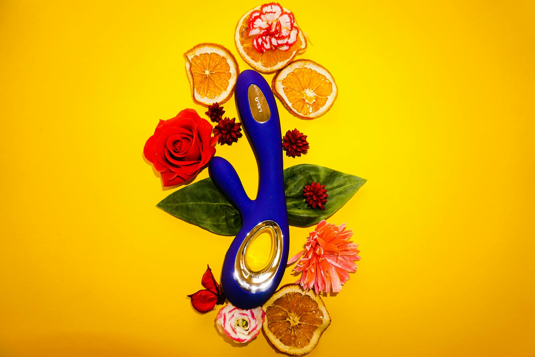 A blue silicone vibrator held in hand against a purple background, promoting self-love and pleasure.