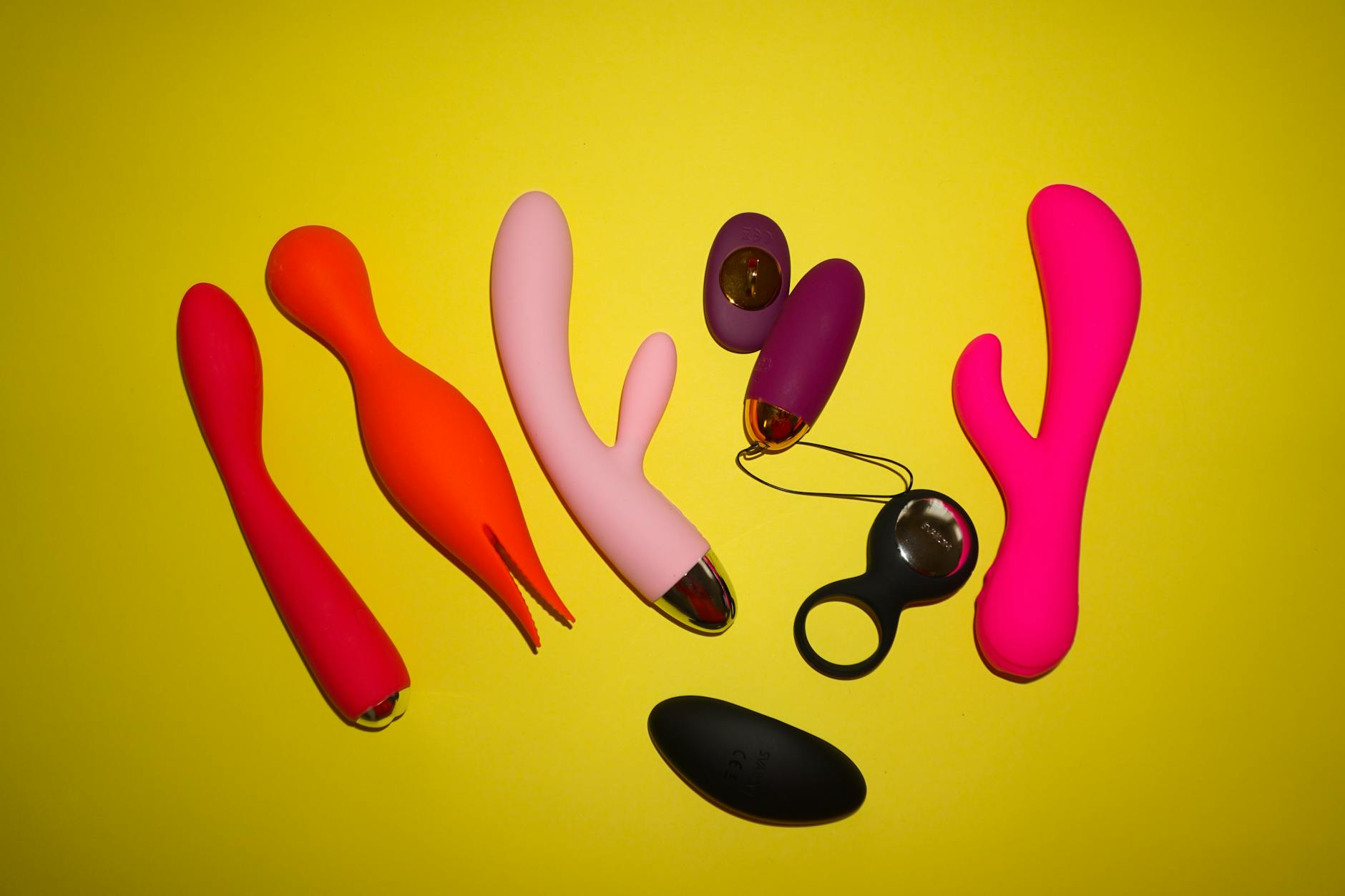 Colorful lemon vibrators and adult toys on a bright yellow background