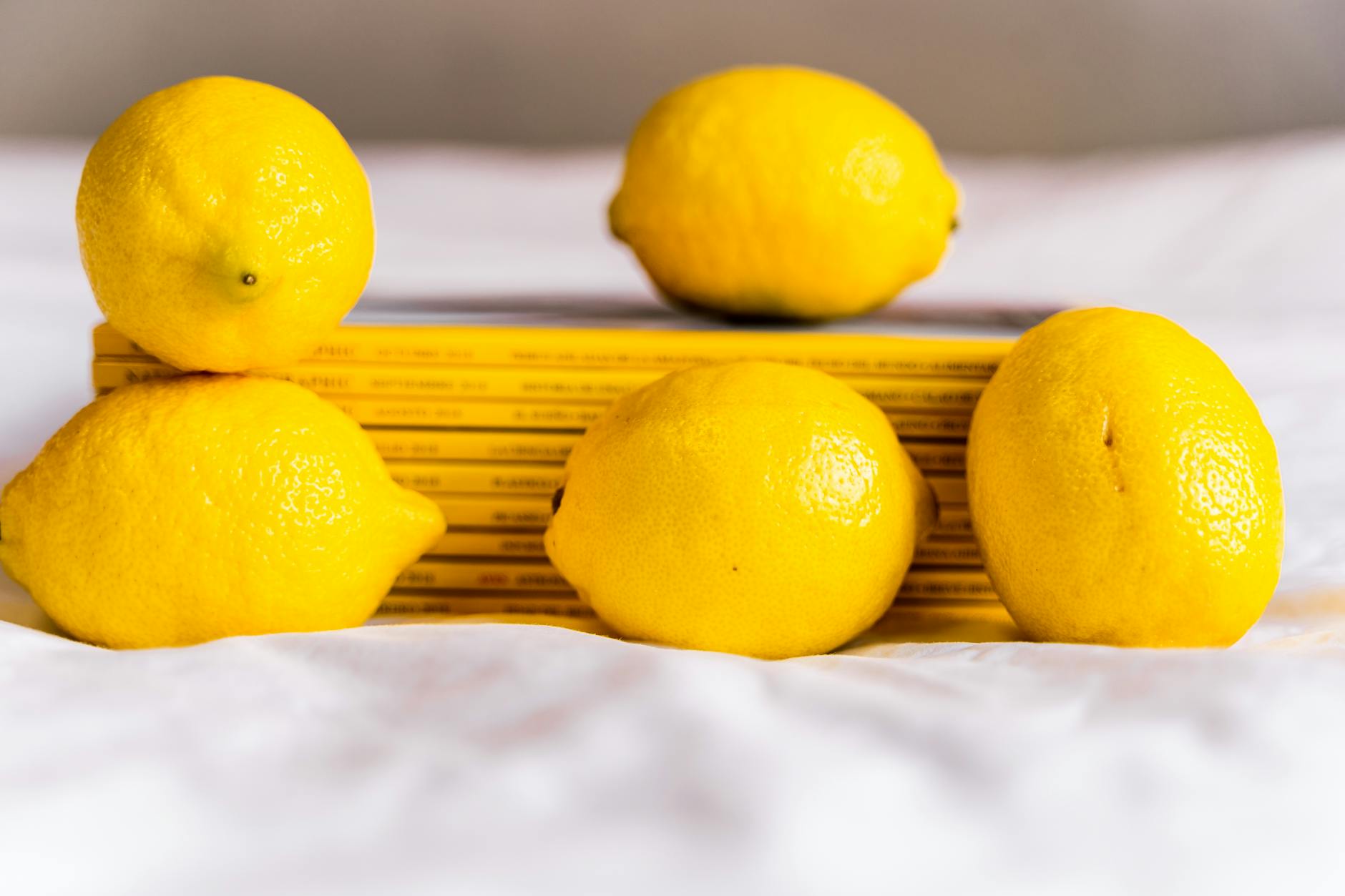 Two women smiling together outdoors with lemon slices, expressing joy and intimacy